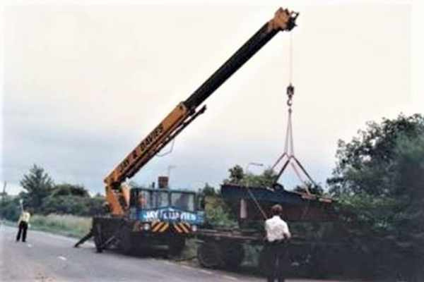 A boat being craned in the Hereford and Gloucester Canal at Monkhide